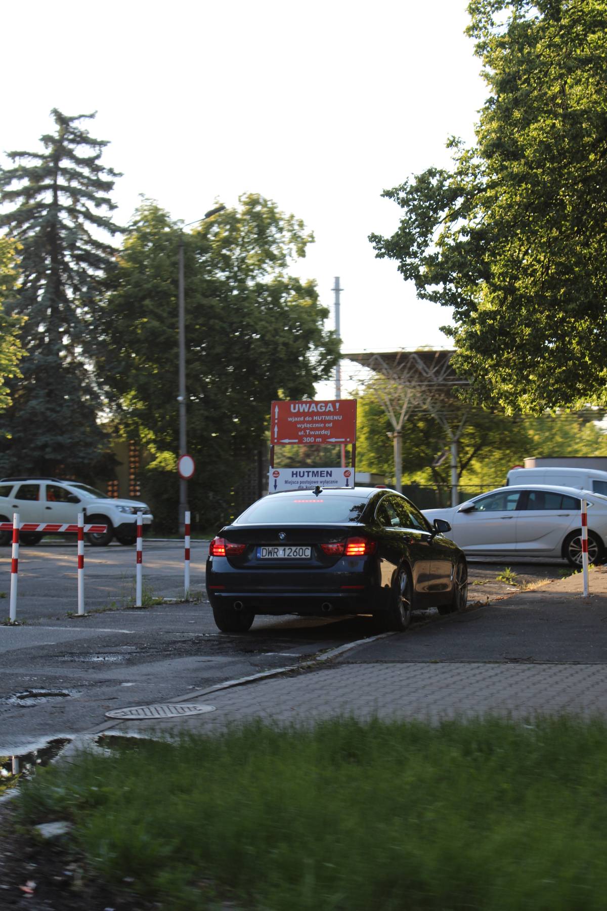 A BMW parks on a curb