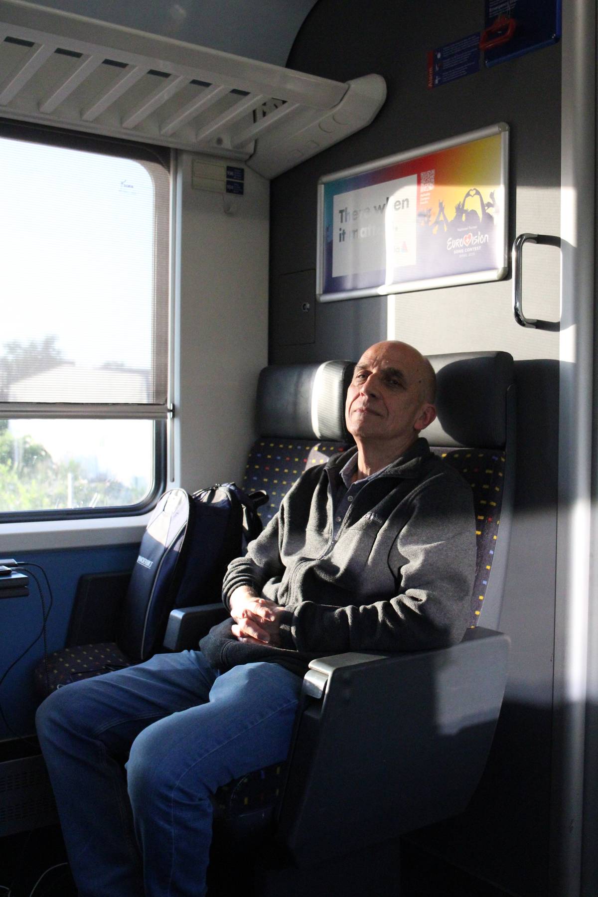 My father gets comfortable on a train ride