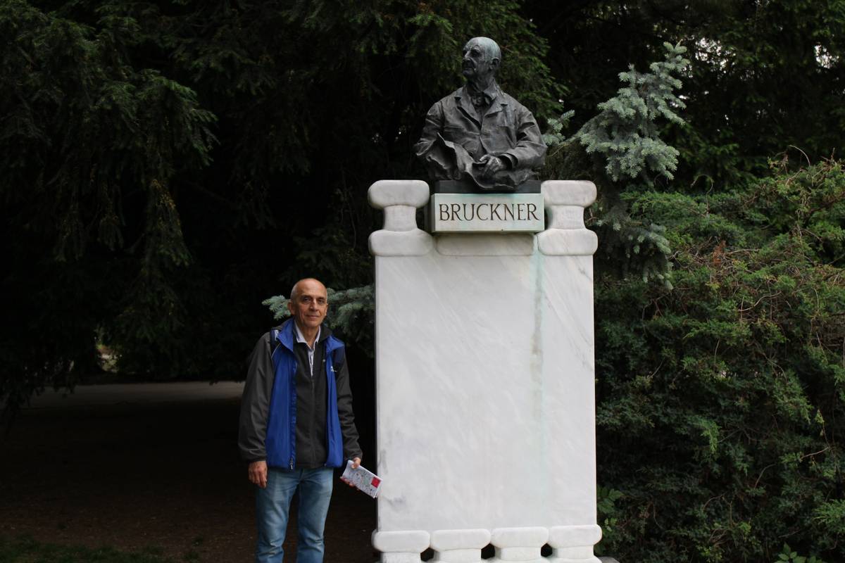 My father stands next to a statue of Bruckner