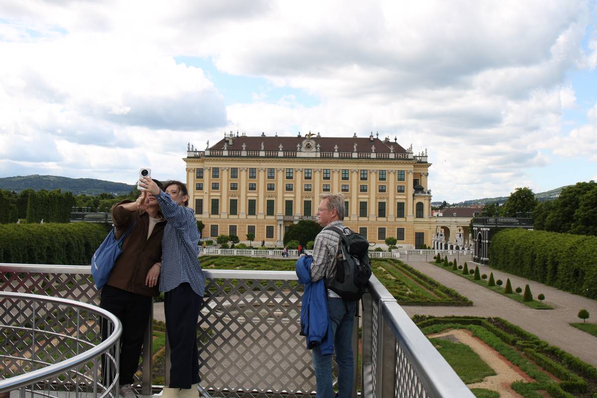A side view of the palace building with tourists taking a selfie