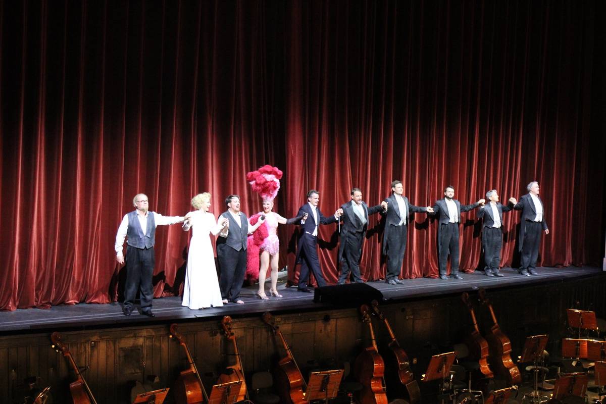 The cast holds hands at the end of their performance