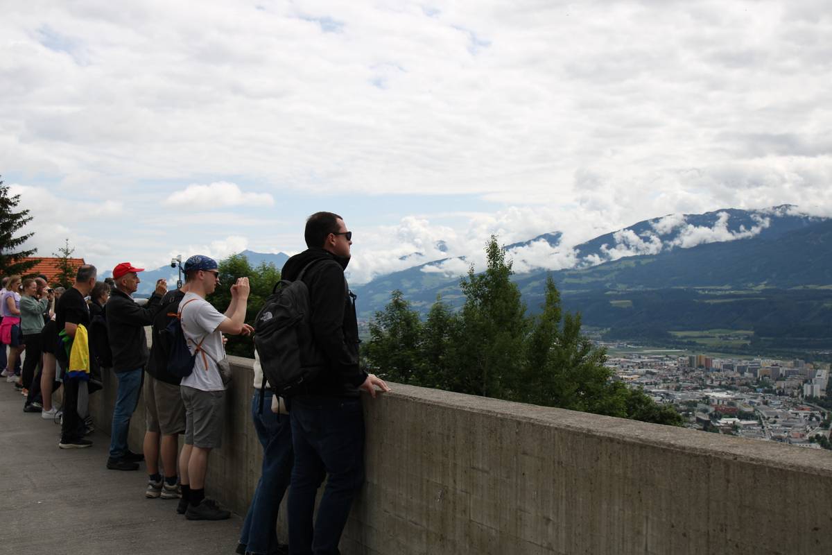Tourists look over a short wall across Innsbruck