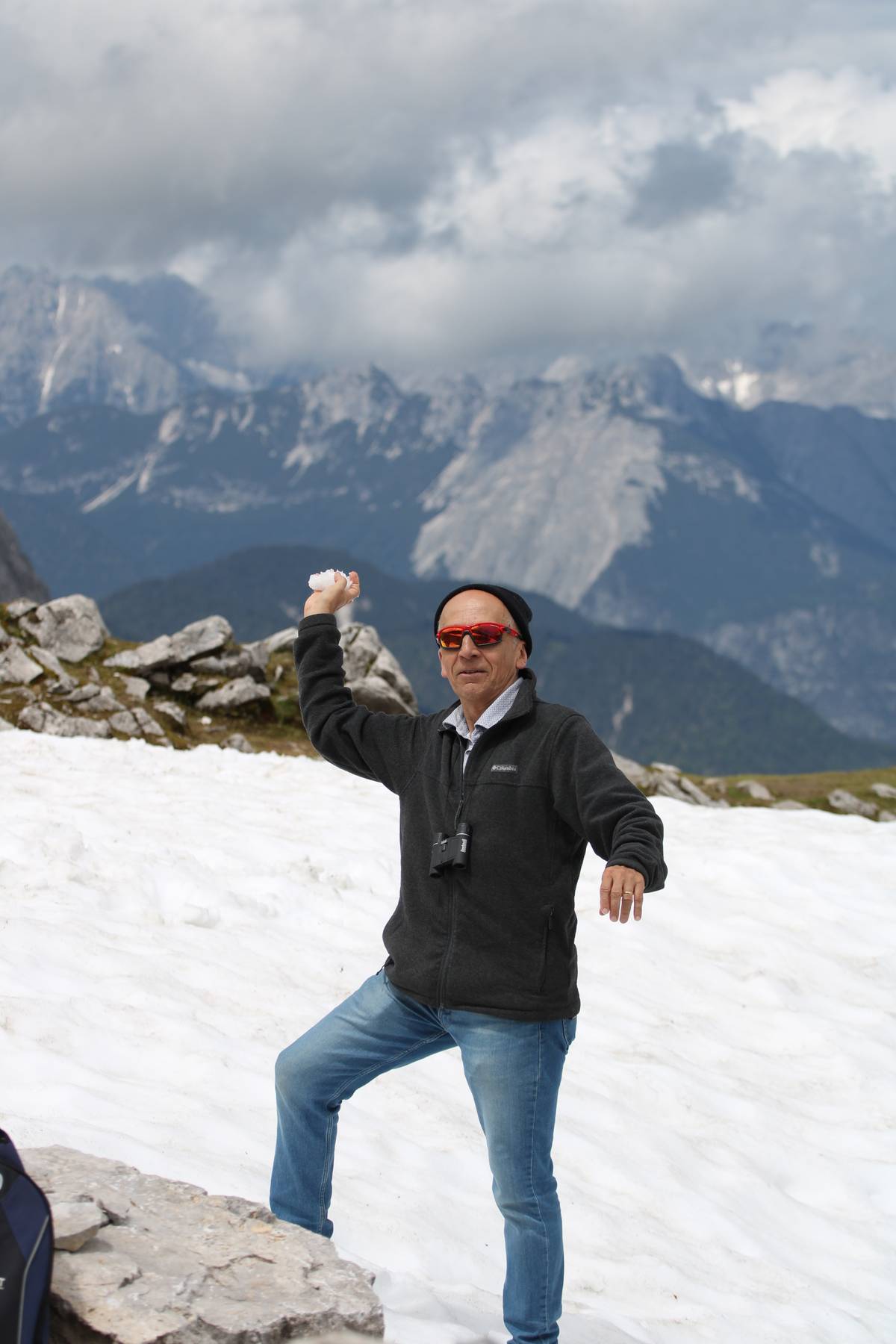 My dad winds up his arm to throw a snowball