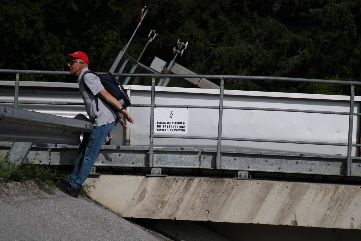 My dad poses as if he's doing the ski jump