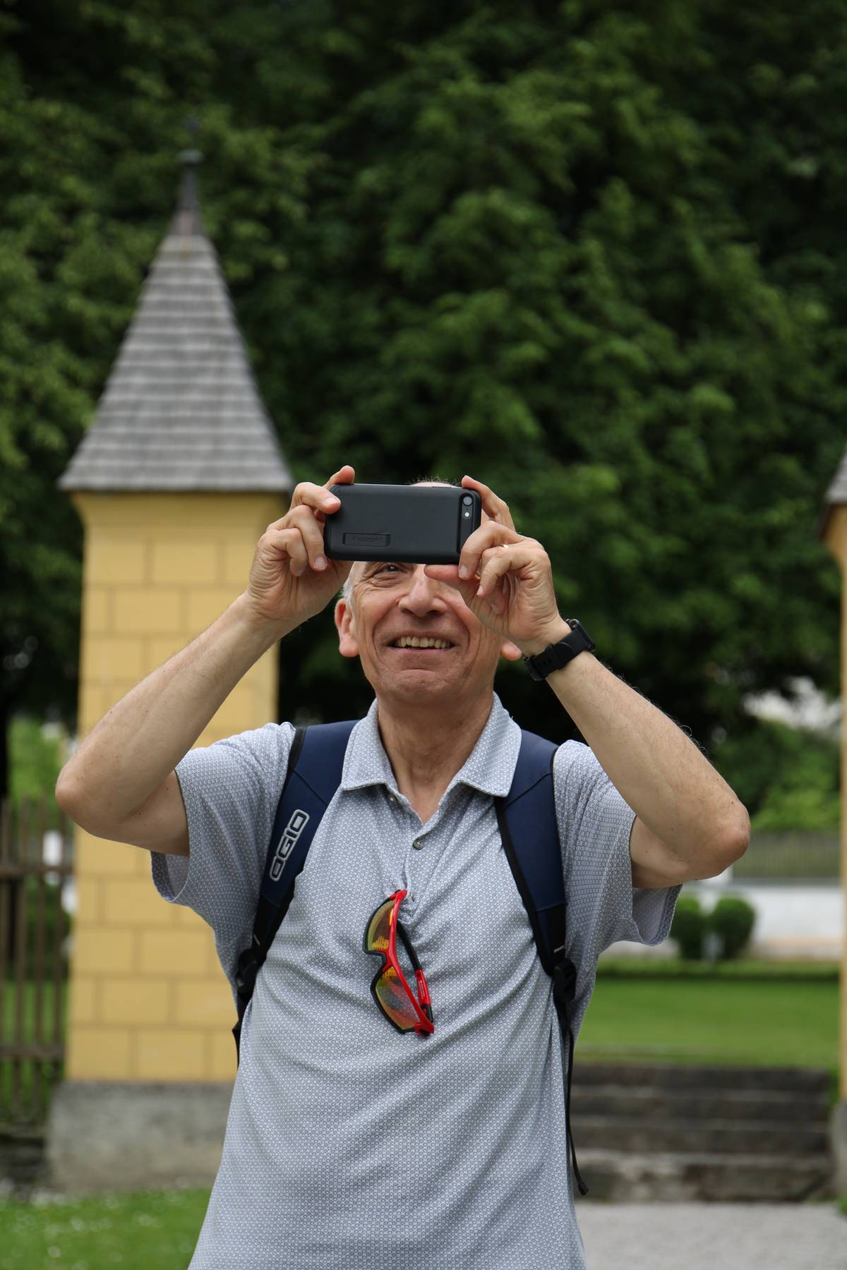 My dad smiles as I take a photo of him taking a photo