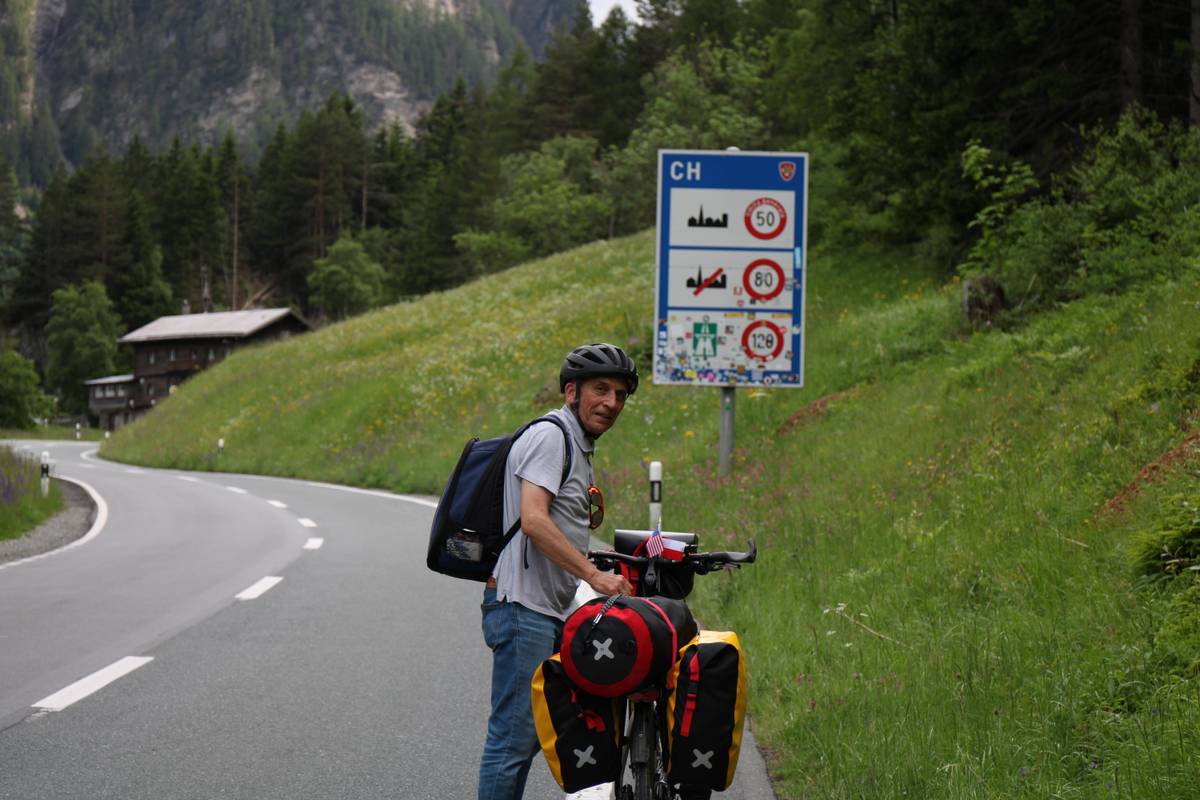 my dad stands with the Swiss speed limit sign behind him
