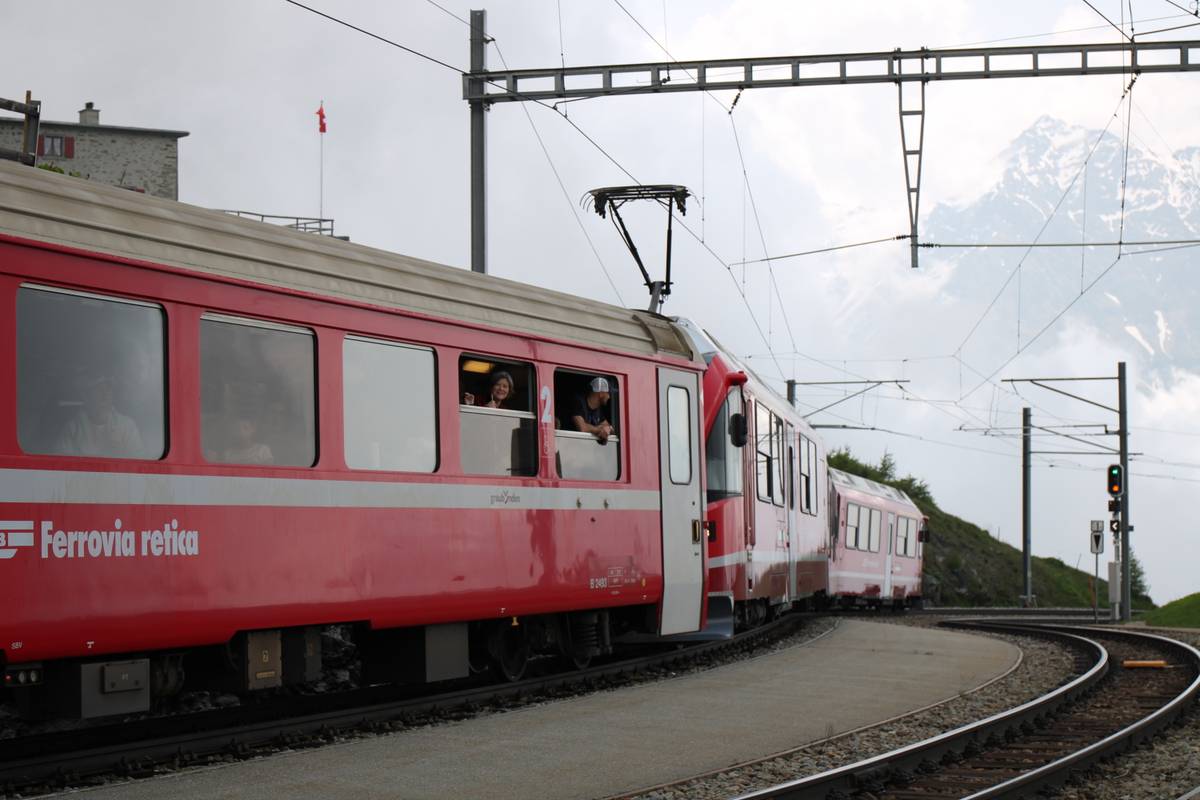 People lean out of windows on the train