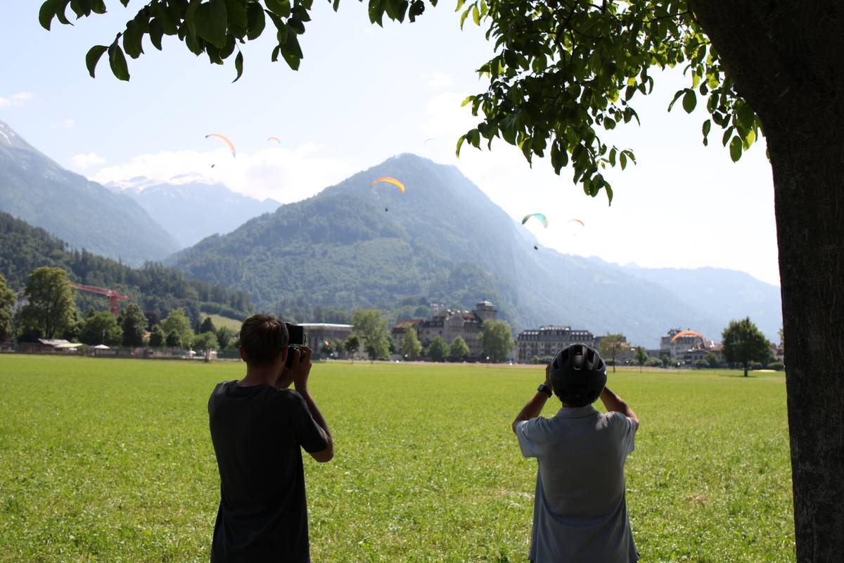 Michael and my dad stand looking at the parachuters