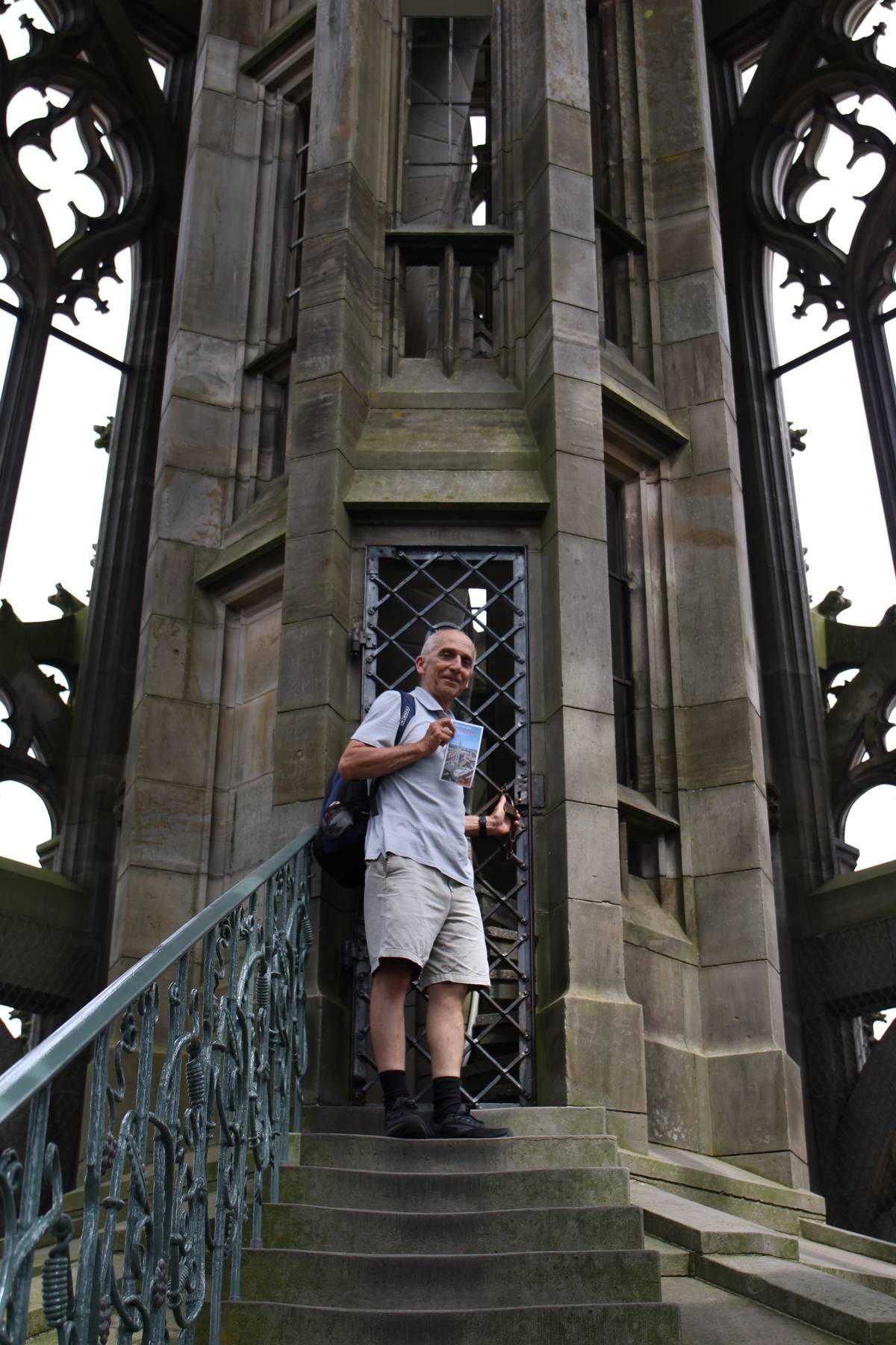 My dad holds a pamphlet while standing in the top level of the church